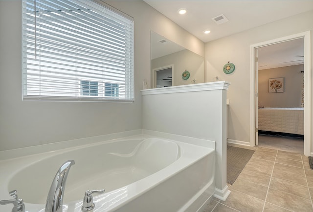 ensuite bathroom with tile patterned flooring, visible vents, connected bathroom, and a bath