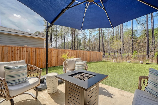 view of patio / terrace with fence and a fire pit