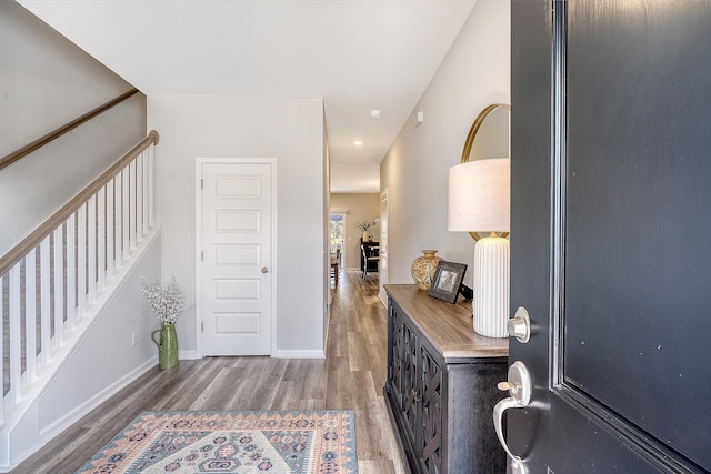 foyer featuring stairs, recessed lighting, baseboards, and wood finished floors