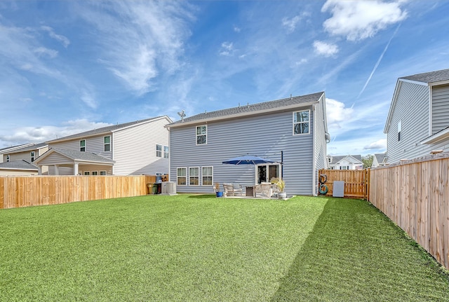 back of property featuring a fenced backyard, central AC, and a lawn