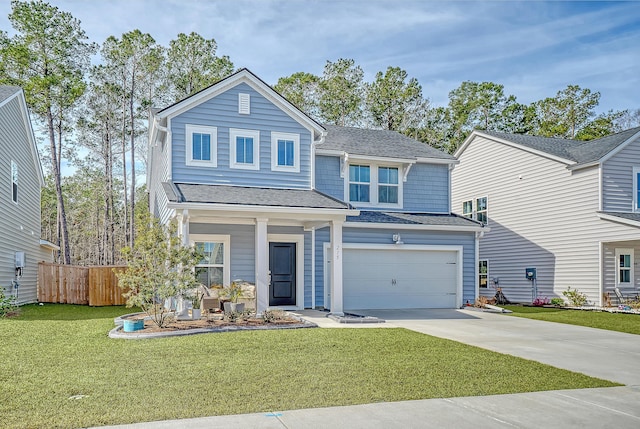 traditional-style home with roof with shingles, concrete driveway, a front yard, fence, and a garage