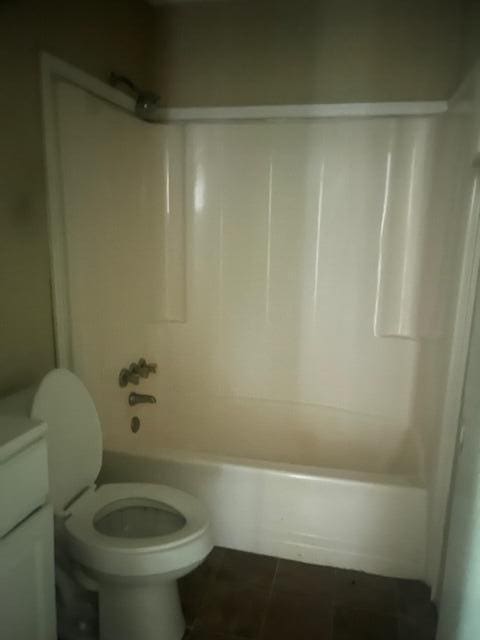 full bathroom with tile patterned flooring, vanity, bathtub / shower combination, and toilet