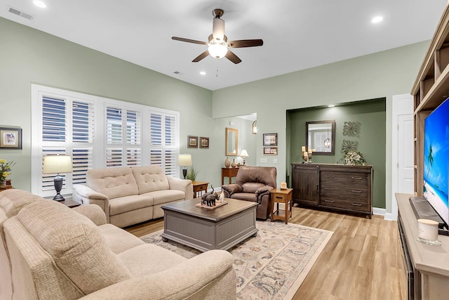 living area with light wood-type flooring, visible vents, a ceiling fan, recessed lighting, and baseboards