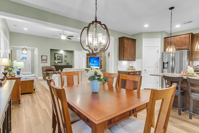 dining space featuring recessed lighting, visible vents, light wood-style flooring, and ceiling fan with notable chandelier