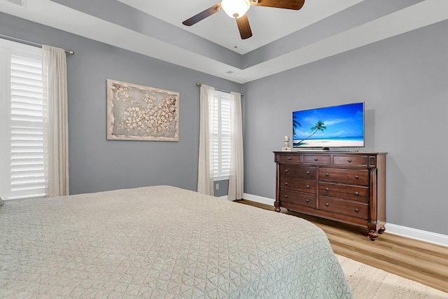 bedroom featuring visible vents, wood finished floors, baseboards, and ceiling fan