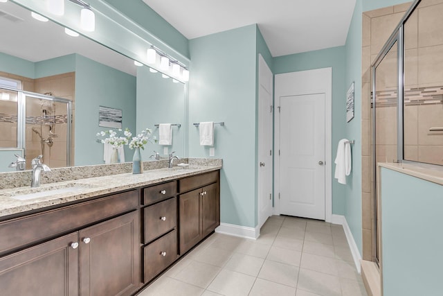 full bathroom with a sink, double vanity, a shower stall, and tile patterned flooring