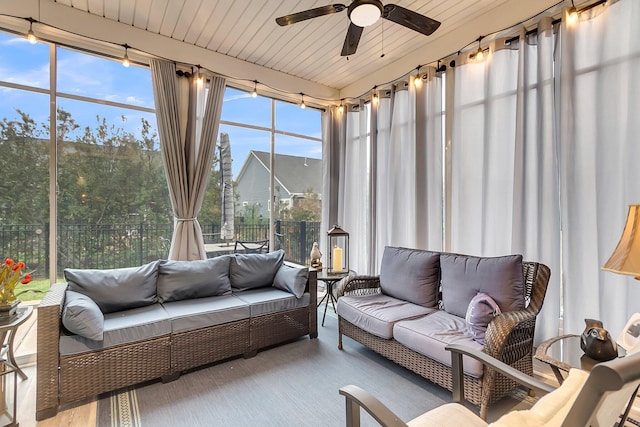 sunroom / solarium featuring wooden ceiling and a ceiling fan