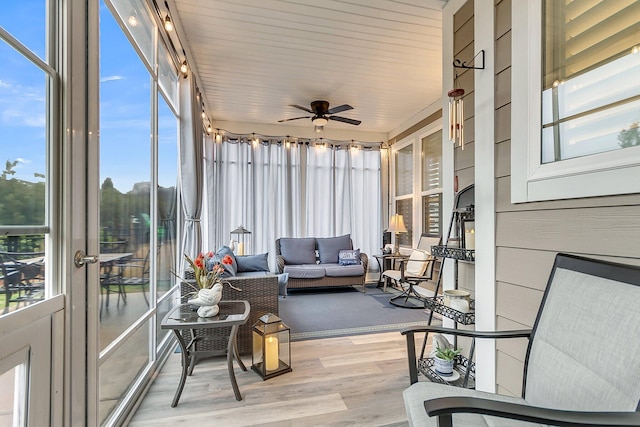 sunroom / solarium with a ceiling fan