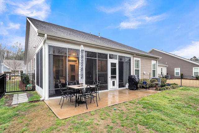 rear view of property featuring a patio area, a yard, fence, and a sunroom