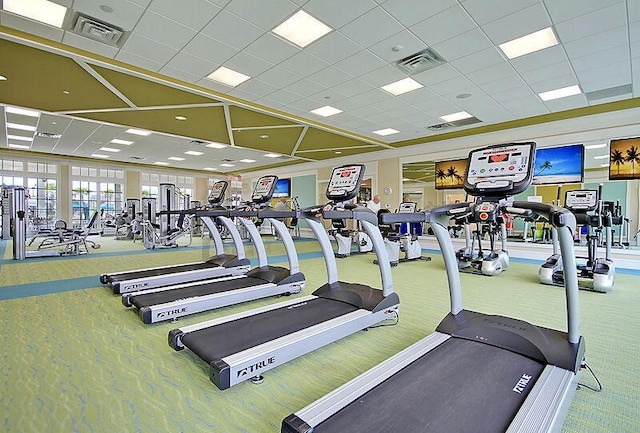 exercise room featuring carpet flooring, visible vents, and a drop ceiling