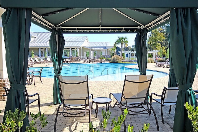 pool featuring a gazebo and a patio