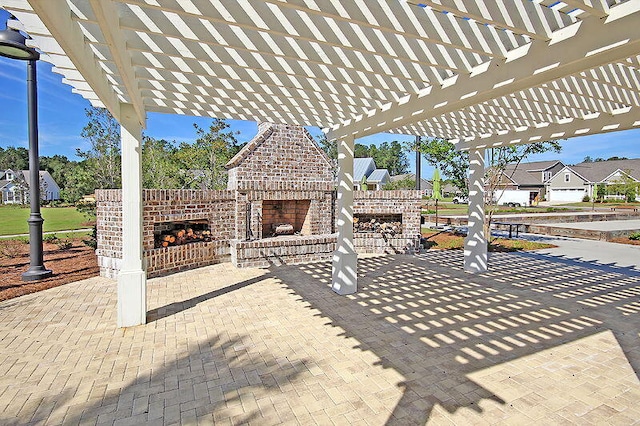 view of patio / terrace with a pergola and an outdoor brick fireplace