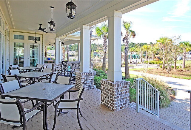 view of patio / terrace with a porch, outdoor dining area, and a ceiling fan