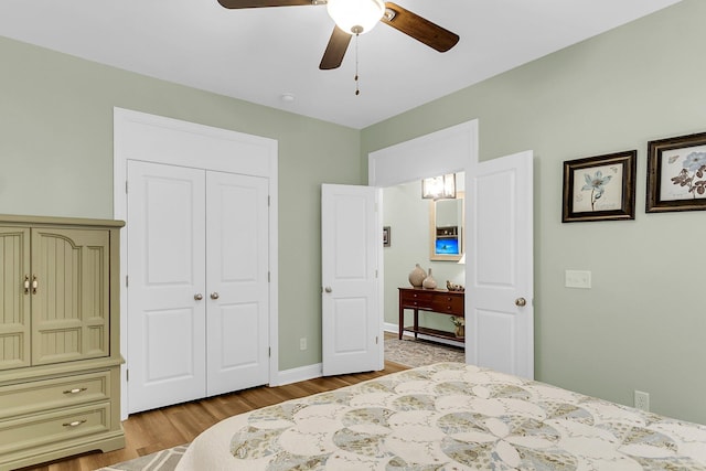 bedroom featuring a closet, a ceiling fan, and wood finished floors