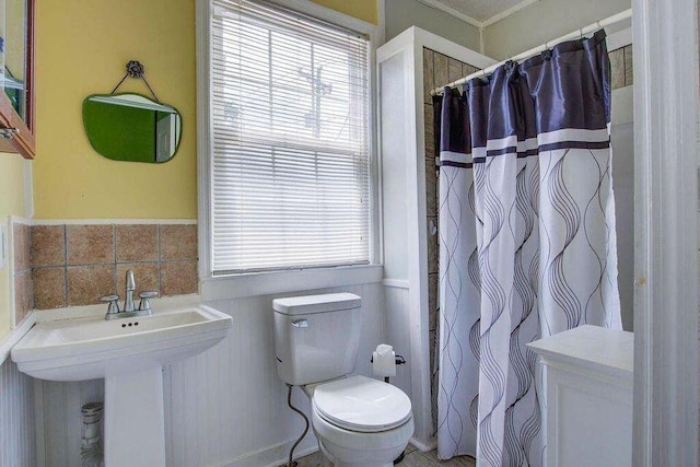 bathroom featuring a shower with curtain, a sink, and toilet