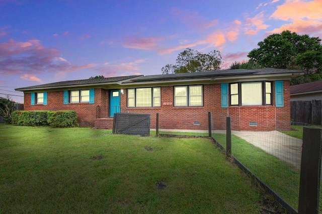 ranch-style house with brick siding, crawl space, and a front lawn