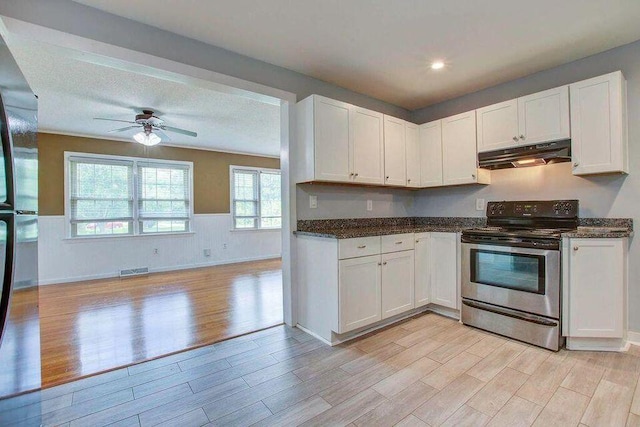 kitchen featuring stainless steel range with electric stovetop, white cabinetry, and under cabinet range hood