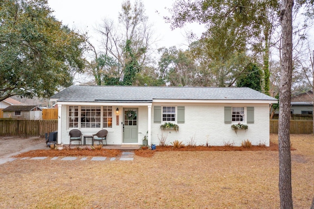 ranch-style house with brick siding and fence