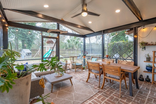 sunroom / solarium with a ceiling fan and lofted ceiling with beams