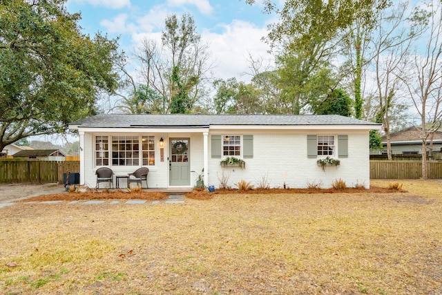 single story home with brick siding and fence