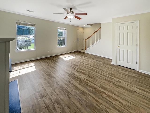 unfurnished living room with crown molding, ceiling fan, and dark wood-type flooring