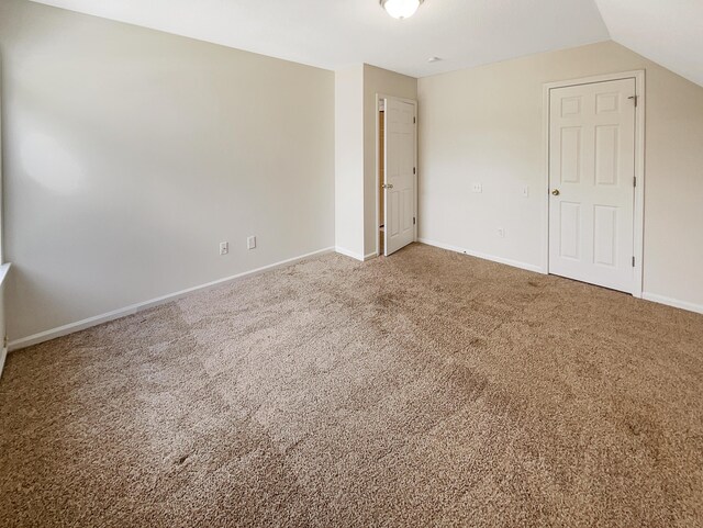 interior space with lofted ceiling and carpet