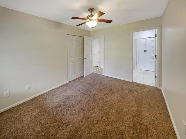 unfurnished bedroom with ensuite bathroom, carpet, and ceiling fan