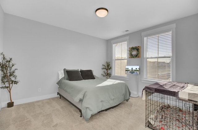 bedroom featuring light carpet