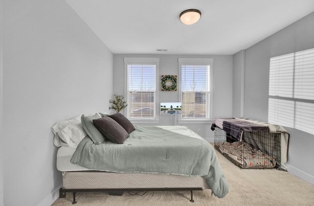 bedroom featuring light carpet