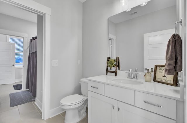 bathroom featuring tile patterned floors, toilet, and vanity