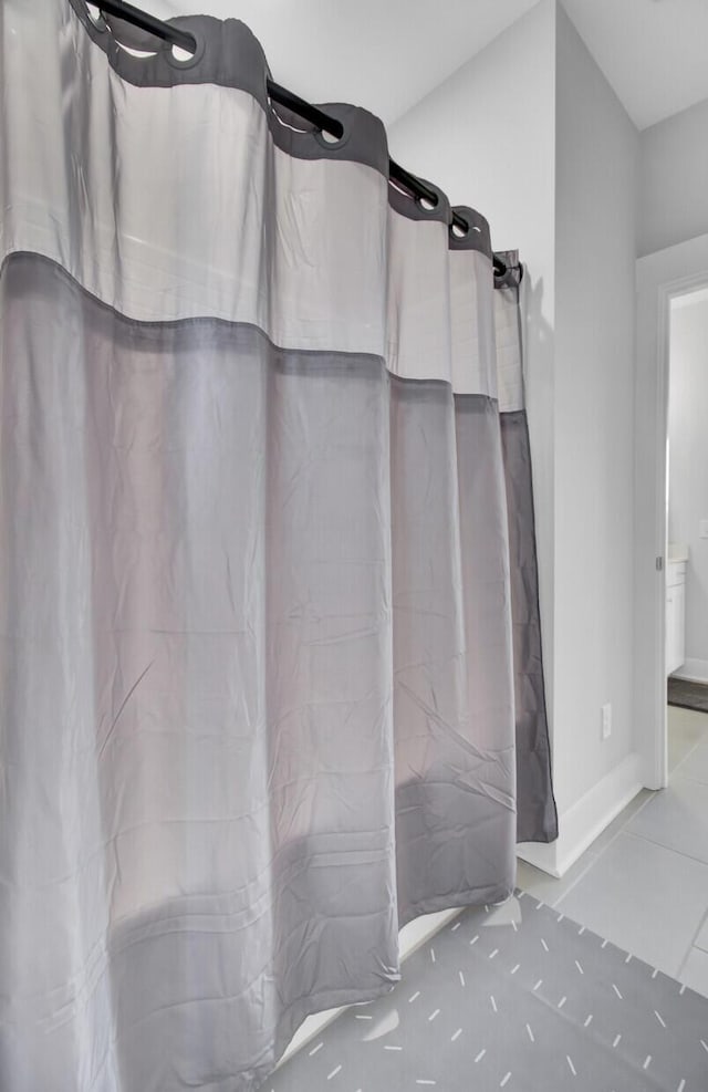 bathroom featuring a shower with curtain and tile patterned floors