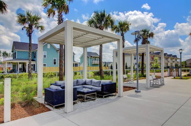 view of community featuring an outdoor hangout area, a pergola, and a patio