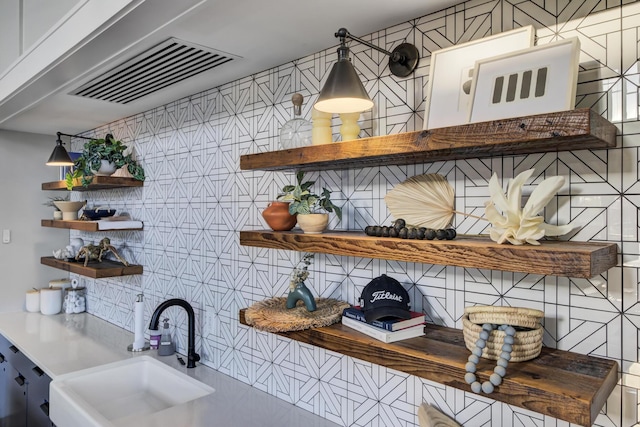 interior space with sink and decorative backsplash