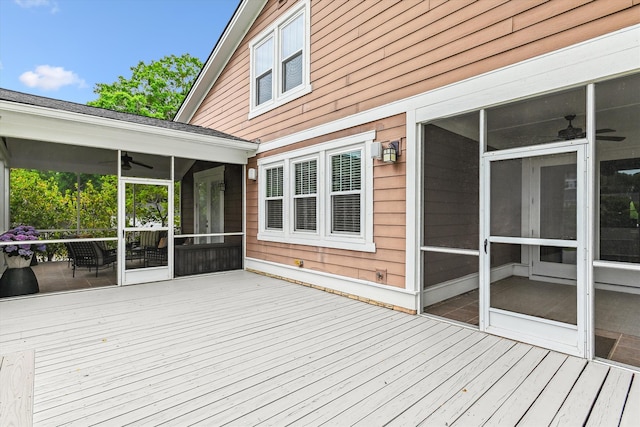 wooden terrace with a sunroom and ceiling fan