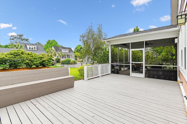 wooden terrace featuring a sunroom and ceiling fan