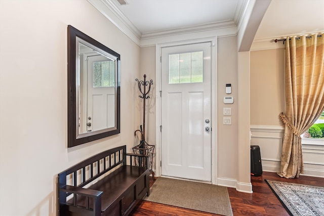 foyer with plenty of natural light, ornamental molding, and dark wood finished floors