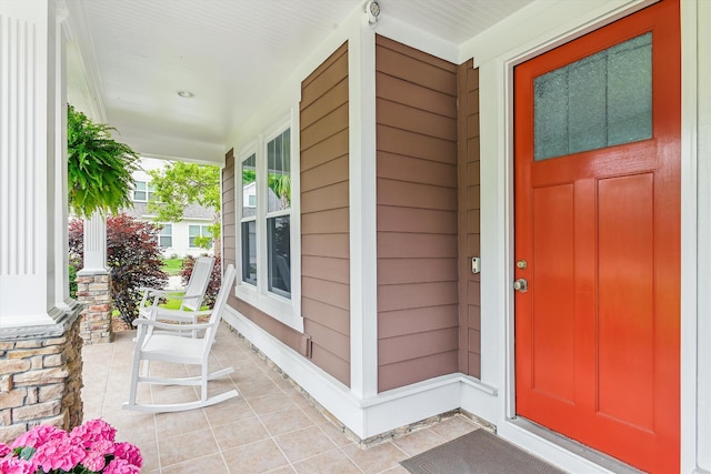 view of exterior entry with covered porch