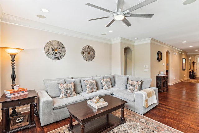 living area with arched walkways, a ceiling fan, wood finished floors, recessed lighting, and ornamental molding