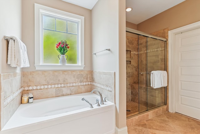 full bathroom with a stall shower, a bath, and plenty of natural light