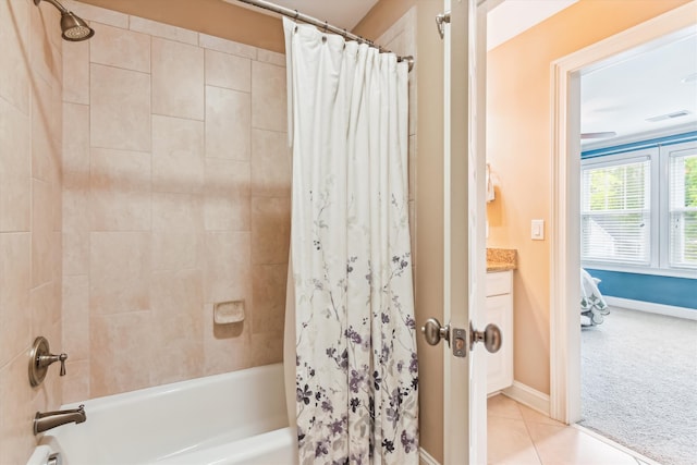 full bath featuring shower / bath combo with shower curtain, baseboards, and tile patterned floors