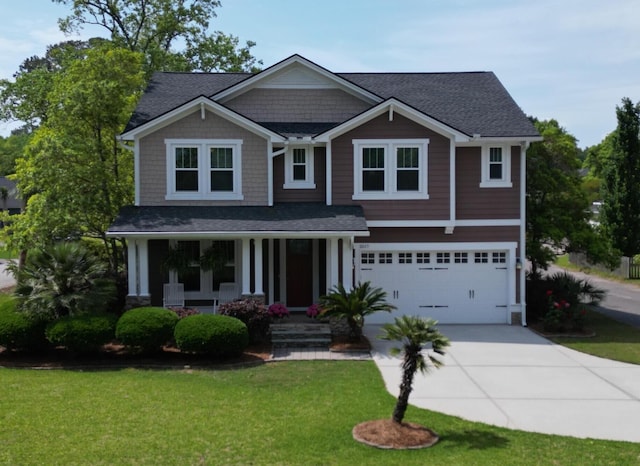 craftsman inspired home with a garage, driveway, a front lawn, a porch, and roof with shingles
