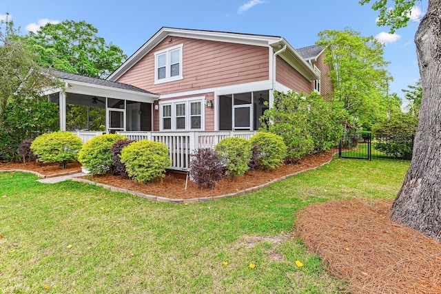 rear view of house featuring a sunroom and ceiling fan
