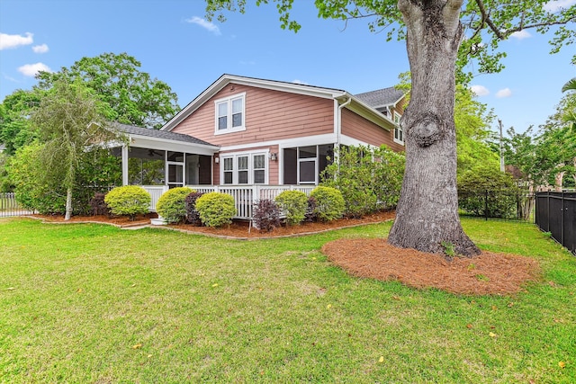 rear view of property with a sunroom and a ceiling fan