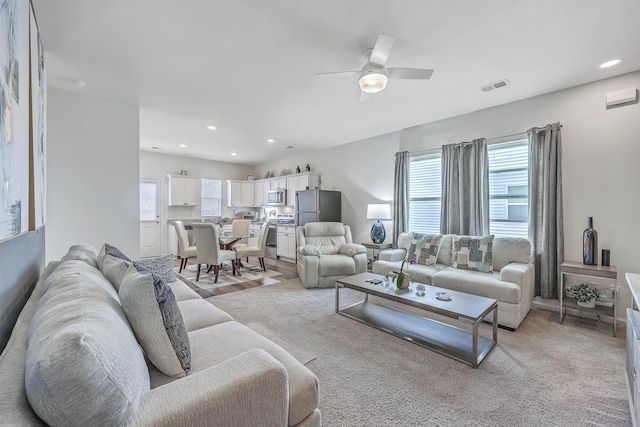 living room with ceiling fan, plenty of natural light, visible vents, and recessed lighting