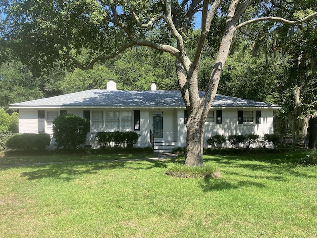 874 Evans Rd, Charleston, SC 29412 - view of front facade with a front lawn, a chimney, and brick siding