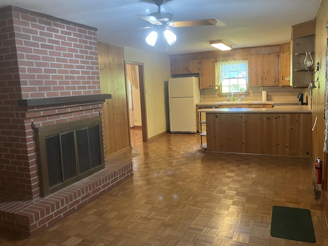 874 Evans Rd, Charleston, SC 29412 - kitchen with freestanding refrigerator, light countertops, ceiling fan, a brick fireplace, and a peninsula
