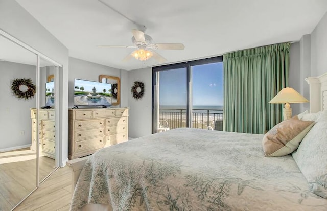 bedroom with ceiling fan, access to outside, a closet, and light wood-type flooring