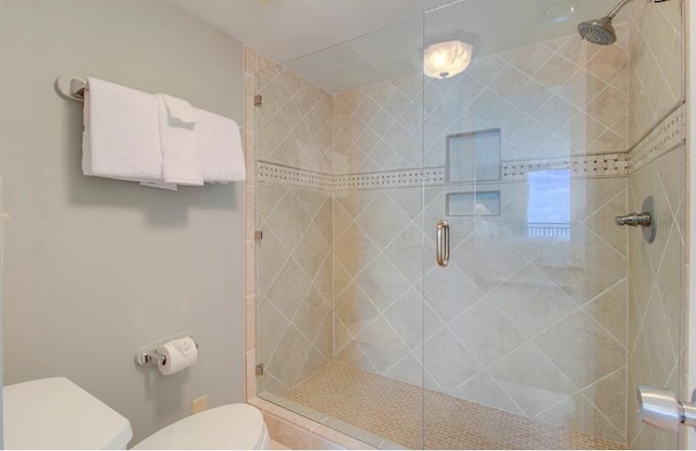 bathroom featuring an enclosed shower and toilet