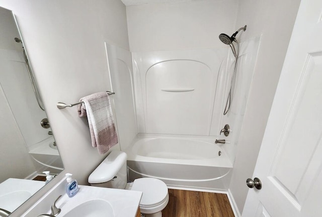 full bathroom with bathtub / shower combination, wood-type flooring, vanity, and toilet