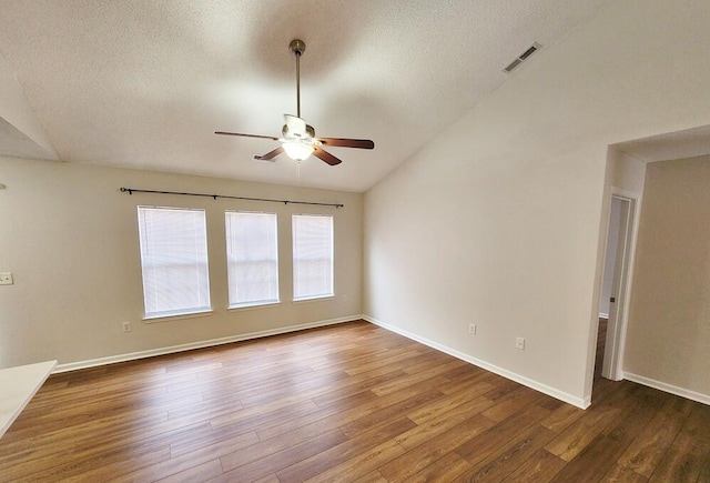 spare room featuring a textured ceiling, ceiling fan, hardwood / wood-style floors, and lofted ceiling